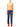 Model wearing Issey Miyake navy pleated trousers with an orange top