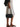 The Row Astra black bowling bag styled with a white skirt and flat sandals