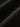 Close-up of the material texture on Studio Nicholson black wide-leg trousers